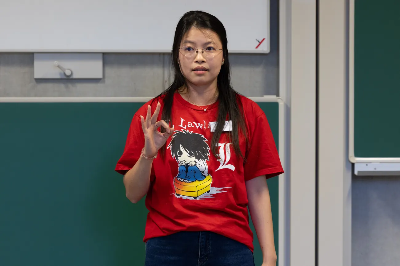 Ying making a precise gesture while speaking