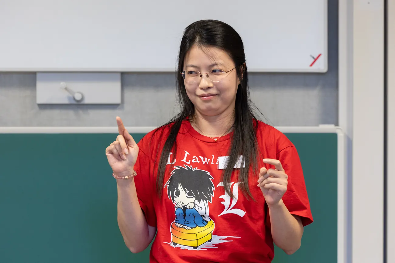 Ying smiling while making a point during her talk